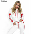 Woman wearing a white tracksuit with red accents on a white background, featuring the brand 'Nibber'.